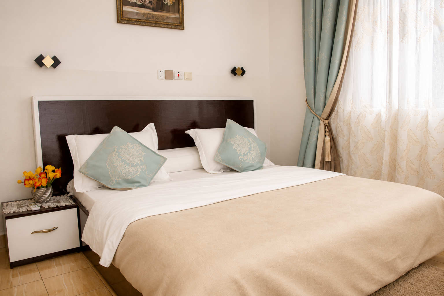 Chambre Standard avec lit en bois massif et coussins bleu ciel